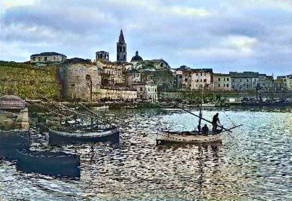 Alghero, riflessi di storia: il porto antico tra mura catalane, barche tradizionali e il fascino senza tempo della Riviera del Corallo